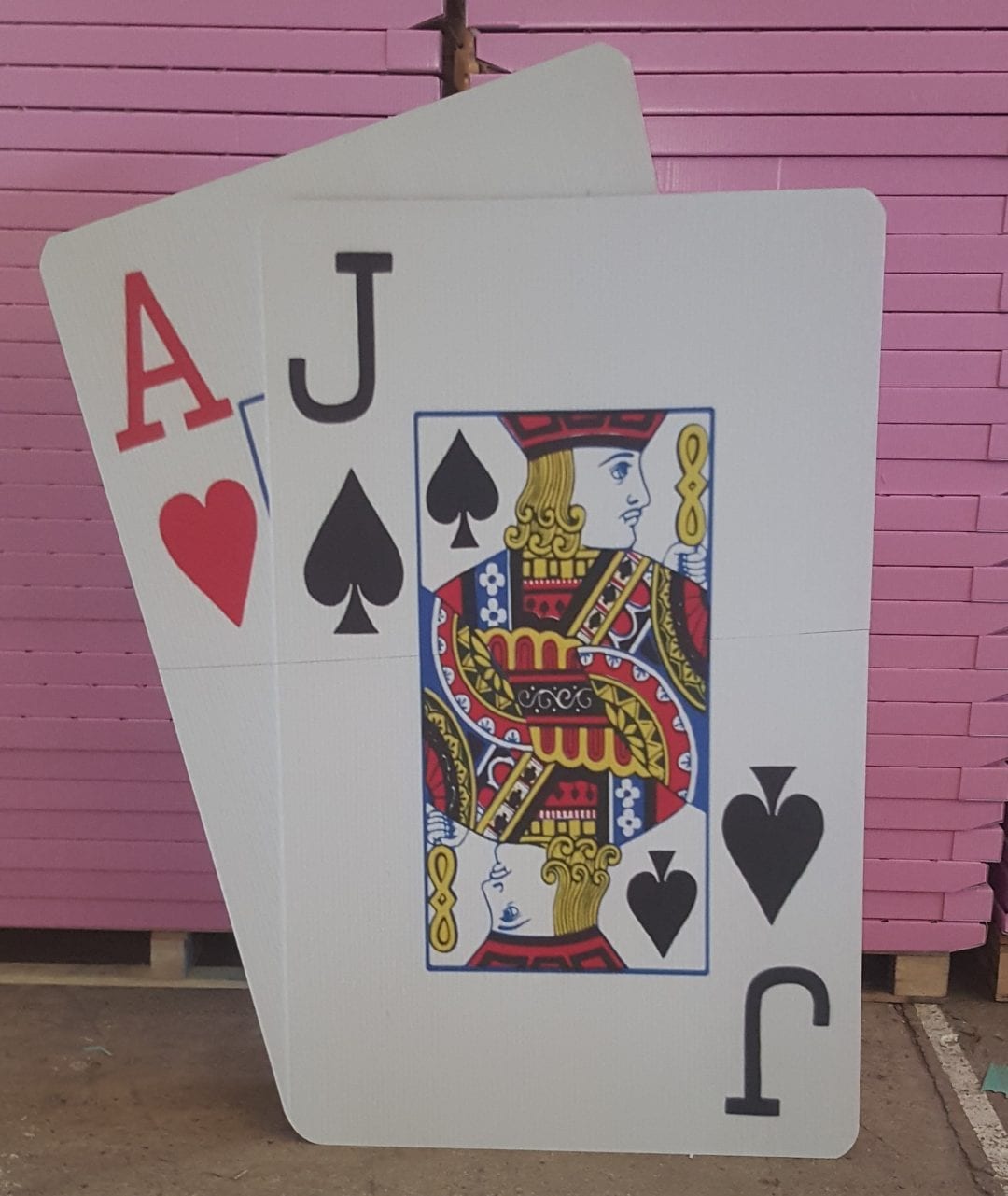 A variety of personalized cardboard cutouts, including one of a man holding a card.