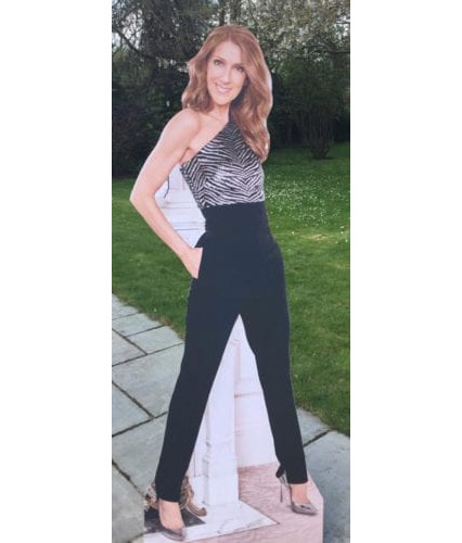 Cardboard cutout of a woman in a stylish black and white outfit outdoors